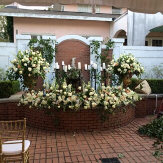 Flowers and candles in outdoor fountain